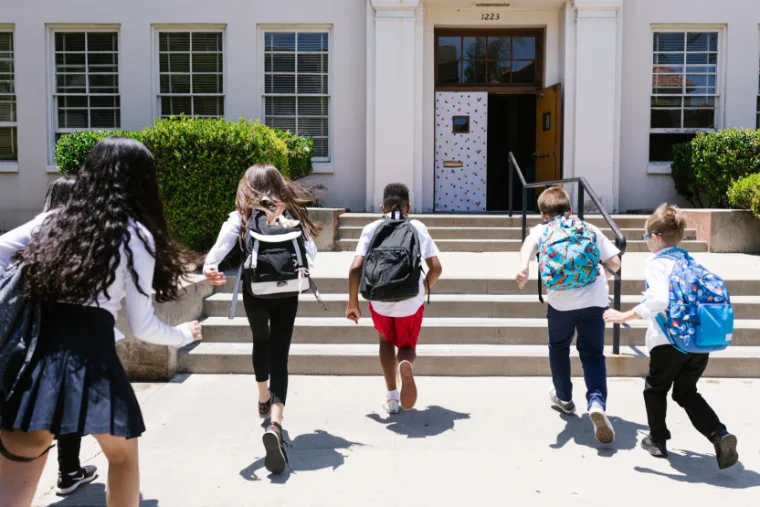 Students running into a Christian school building
