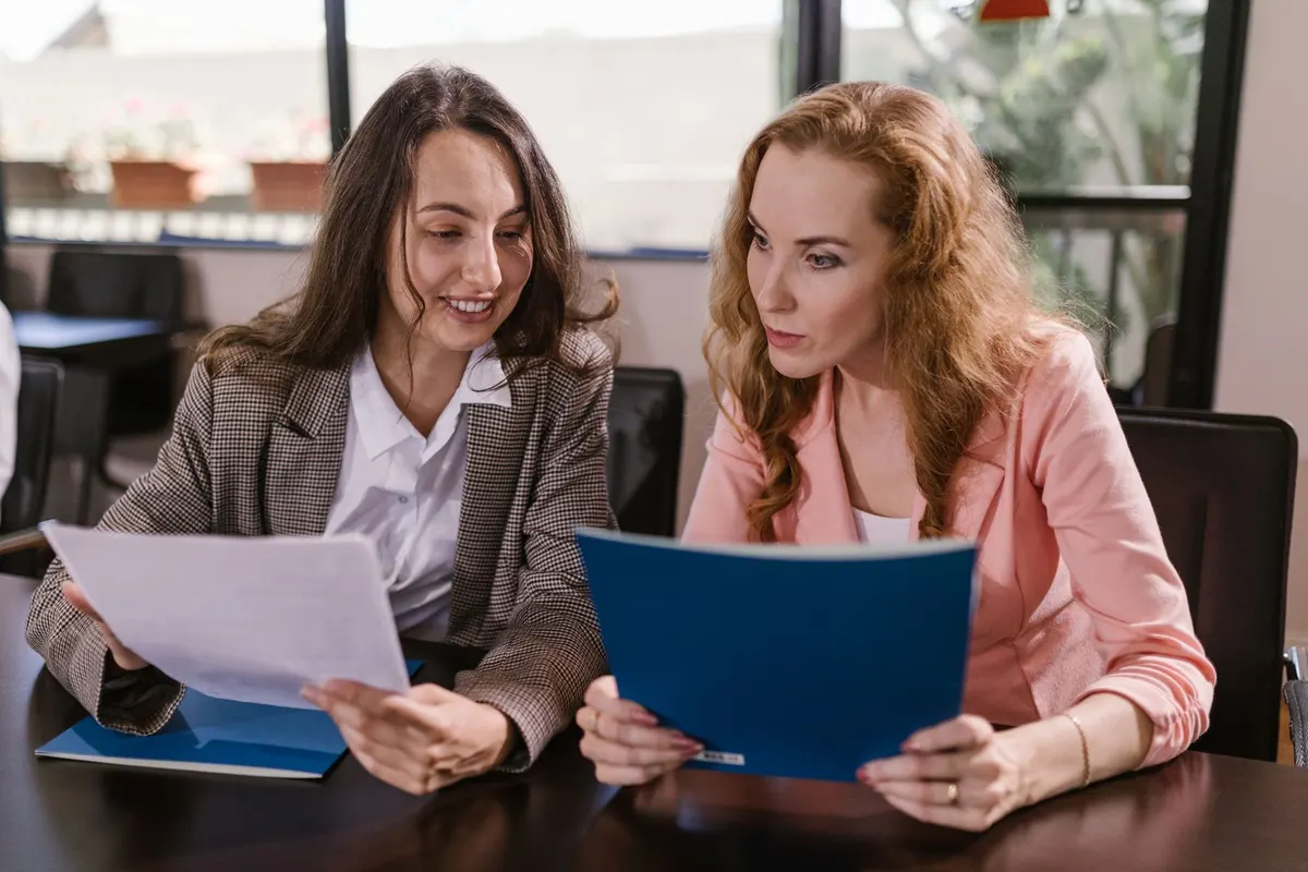 Two ministry leaders reading through a printed document together
