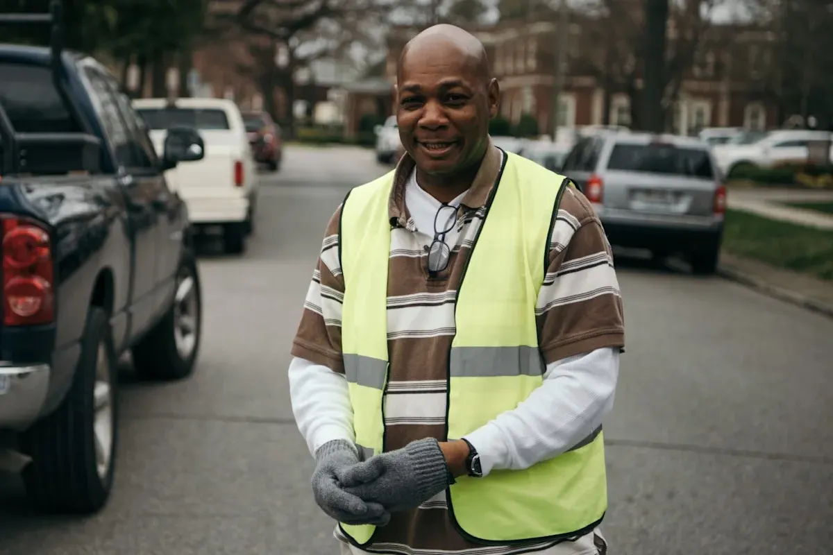A ministry safety team volunteer in a high visibility vest in the parking lot